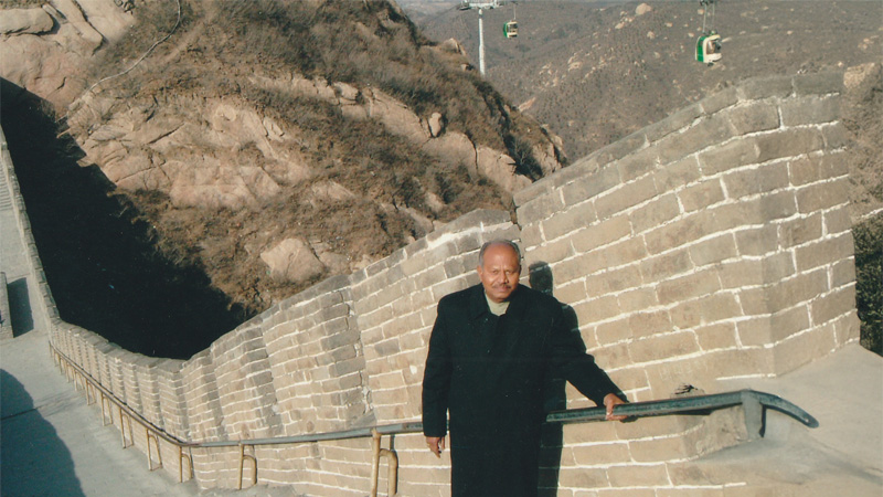 Dr. David Dharmadas at the Great Wall of China, symbolizing the connection between ancient Vastu Shastra and global architectural heritage.